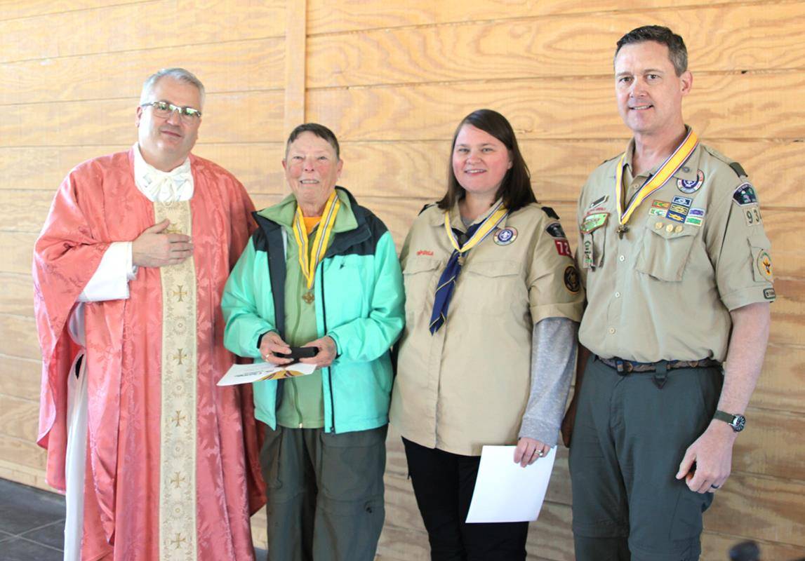 Pictured with Monsignor Winslow are adult award recipients: (from left) Jody McManus of Pack 443 in Salisbury, recipient of Catholic Scouting's highest honor, the St. George Emblem; and Bronze Pelican recipients Amanda Balwah and Lee Danhauer.