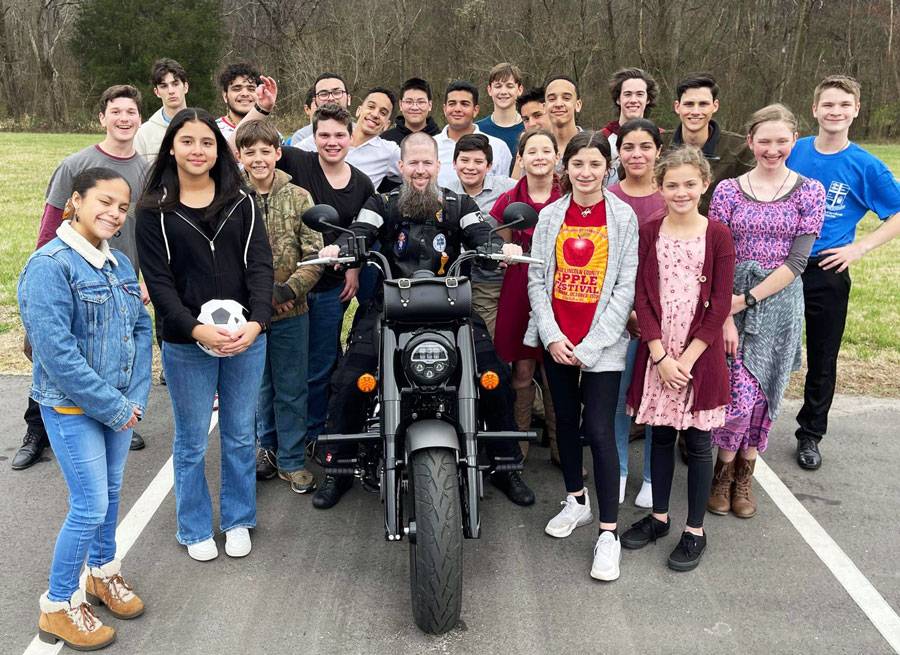 Father Miller w youth and motorcycle 2023 FB (Copy)