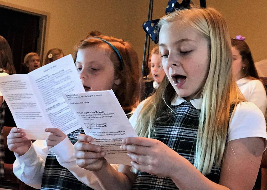 Students at St. Mark School opened Catholic Schools week by participating in the Jan. 29 11 a.m. Mass at the Huntersville parish. Students served as lectors, altar servers, gift presenters and singers in the choir.  (Photos provided by Amy Burger)