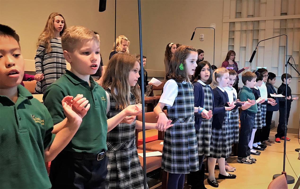 Students at St. Mark School opened Catholic Schools week by participating in the Jan. 29 11 a.m. Mass at the Huntersville parish. Students served as lectors, altar servers, gift presenters and singers in the choir.  (Photos provided by Amy Burger)