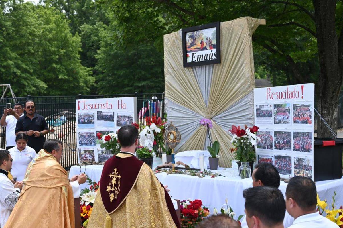 Fr. José Juya, parish vicar, lead the Eucharist Processional with Fr. Lucas Rossi, pastor at St. Michael Church in Gastonia. A crowd of parishioners follow them through the facilities until gather at Mass.