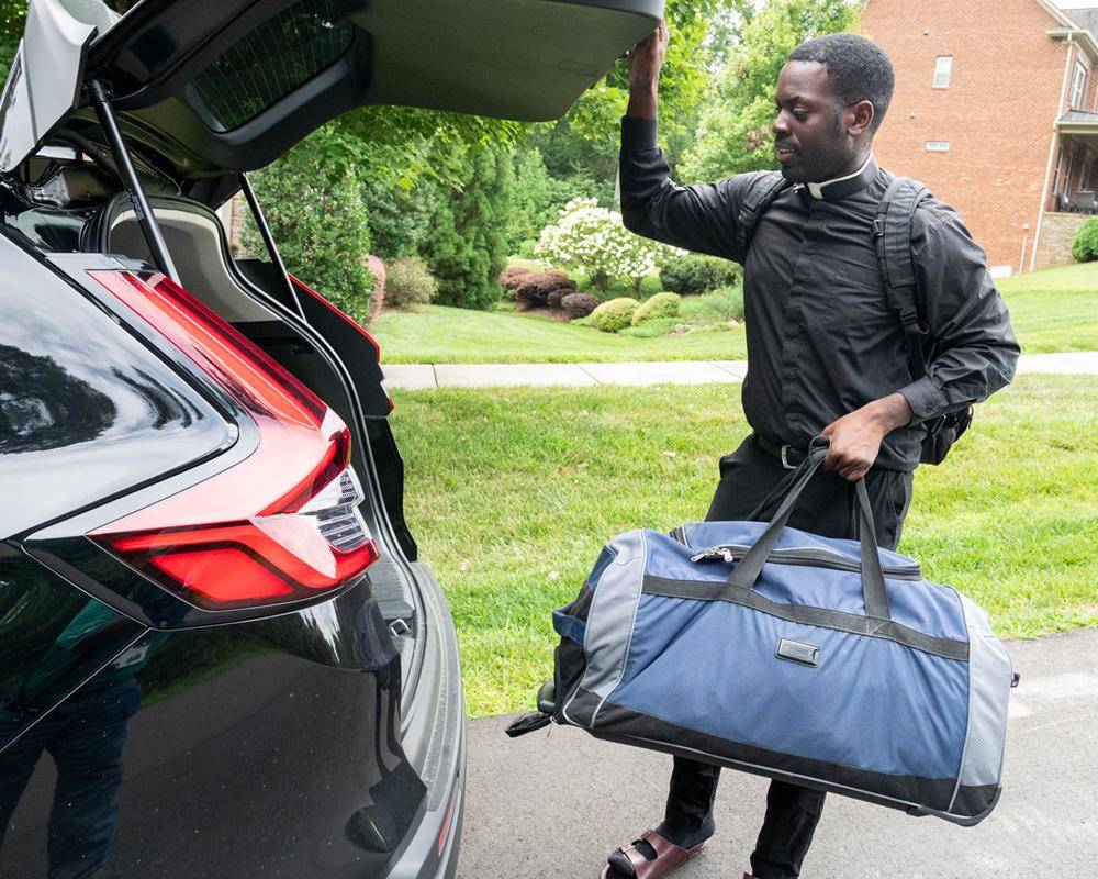 Nearly two dozen priests are settling into new parish assignments across the diocese, including newly ordained Father Chinonso Nnebe-Agumadu, pictured above, as he moves into the rectory at St. Mark Catholic Church in Huntersville. (Photos by Troy Hull ) 