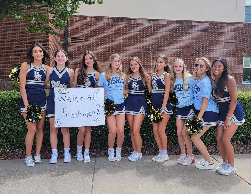 Cheerleaders welcome students to Bishop McGuinness High School.