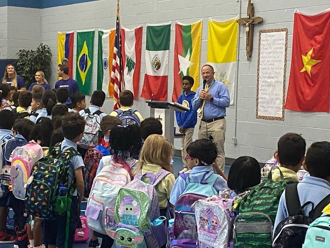 Principal Tyler Kulp welcomed new and returning students and staff at the morning assembly at Our Lady of the Assumption School.