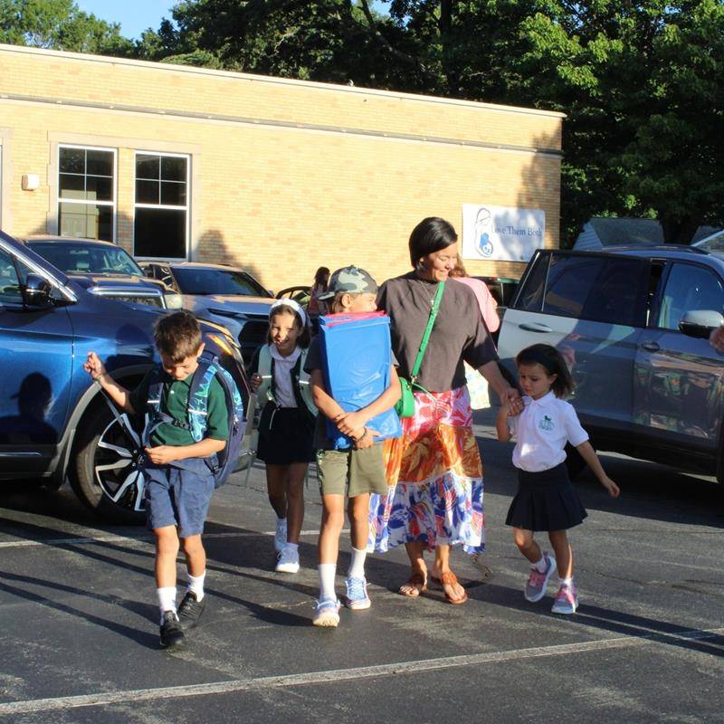 Students, faculty and parents smile for the first day of school at St. Leo School.