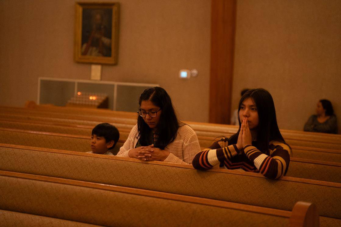 Parishioners pray during Mass.
