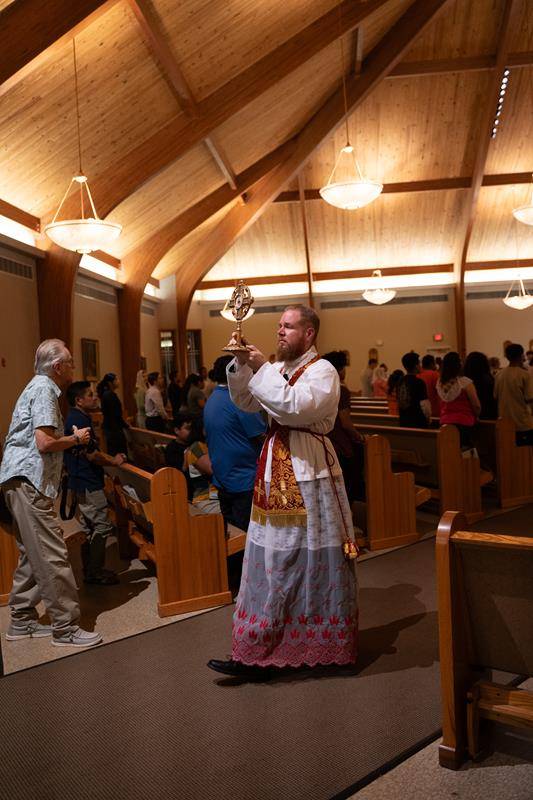 Father Carter carried the relic of the True Cross in a procession.