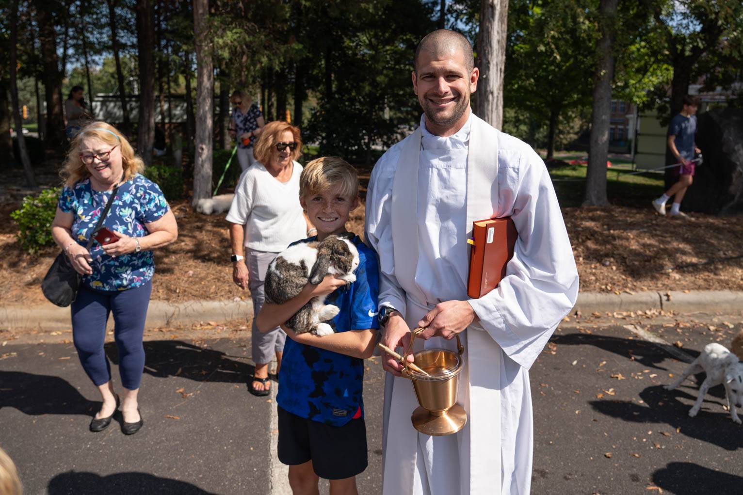 St. Matthew Parish's Father Darren Balkey spent the afternoon making sure every pet – including one large rabbit – received a blessing.