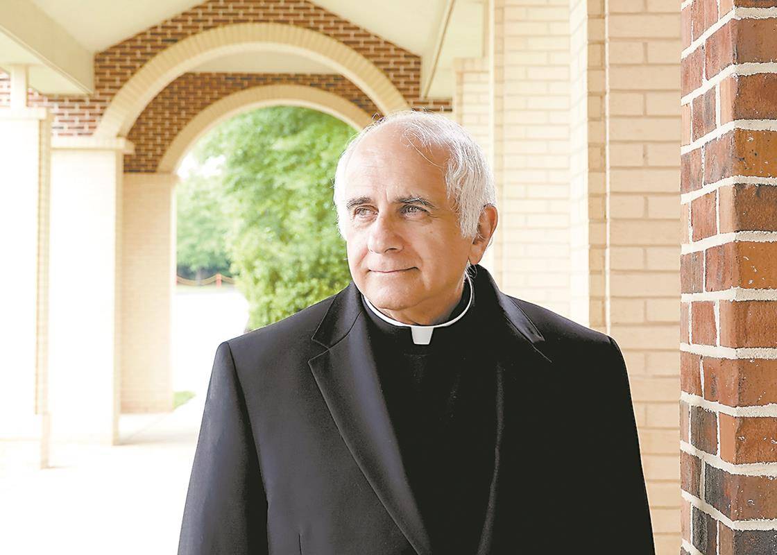 Msgr. Bellow pauses outside St. Mark Church. He served as pastor of the Huntersville parish from 2004 to 2013