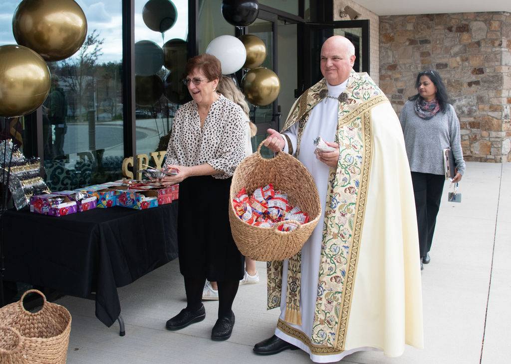 Monsignor Marcaccio handed out animal crackers to the students after the blessing and dedication