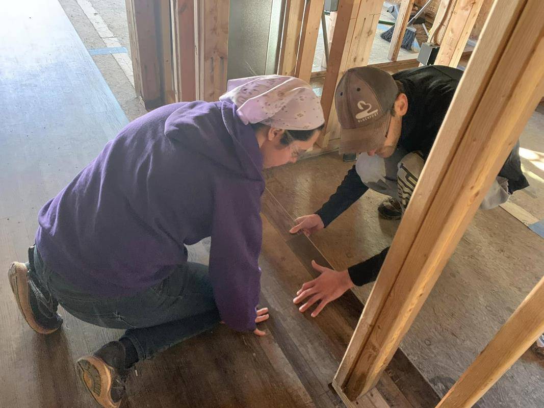 Winston Salem's Frassati young adult group volunteers to install flooring at a Habitat for Humanity home in eastern Winston-Salem.