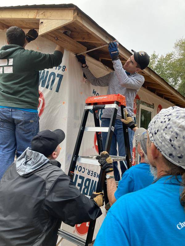Father Peter Ascik helps build a Habitat for Humanity home with his Shelby parishioners and Christians from other local churches.
