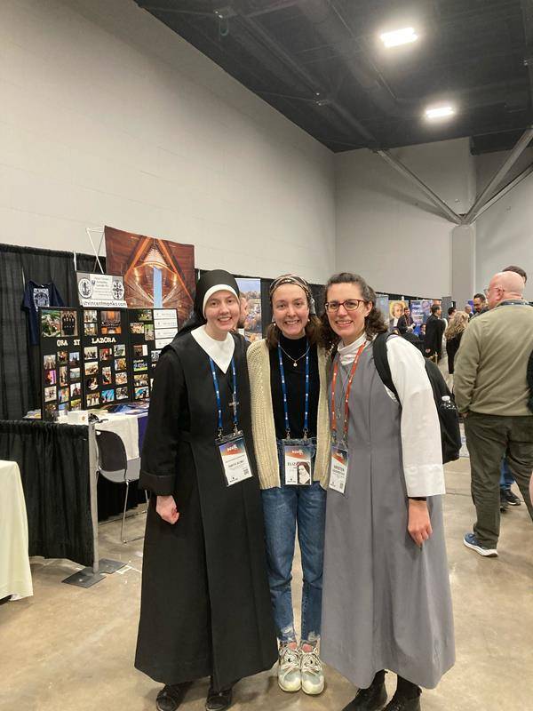 Liz Herpy from Our Lady of Grace Parish in Greensboro reunited with friends Sister Alexandria (left) of the Sisters of Charity of Our Lady, Mother of the Church, and Kristen (right) a postulant with the Sister of St. Francis of the Martyr St. George.