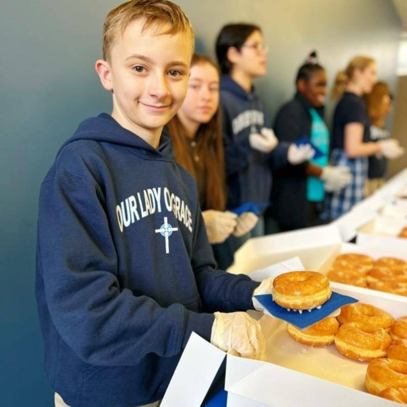The students took the lead in engaging in acts of service. Following the Mass service, parishioners gathered for a Donut Social. 