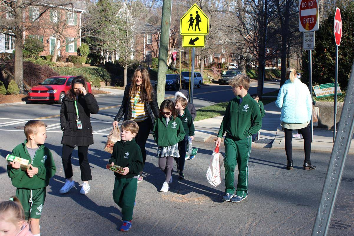 Fifth-graders helped their prayer partner kindergarteners prepare healthy, trail mix bags that will be sold for $1 to benefit Catholic Charities. 