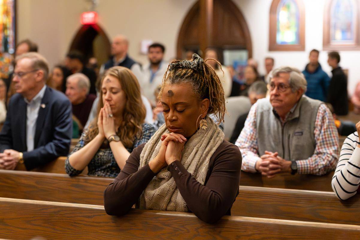 Faithful attend the 7:30 a.m. Ash Wednesday Mass at St. Peter Church in Charlotte. 