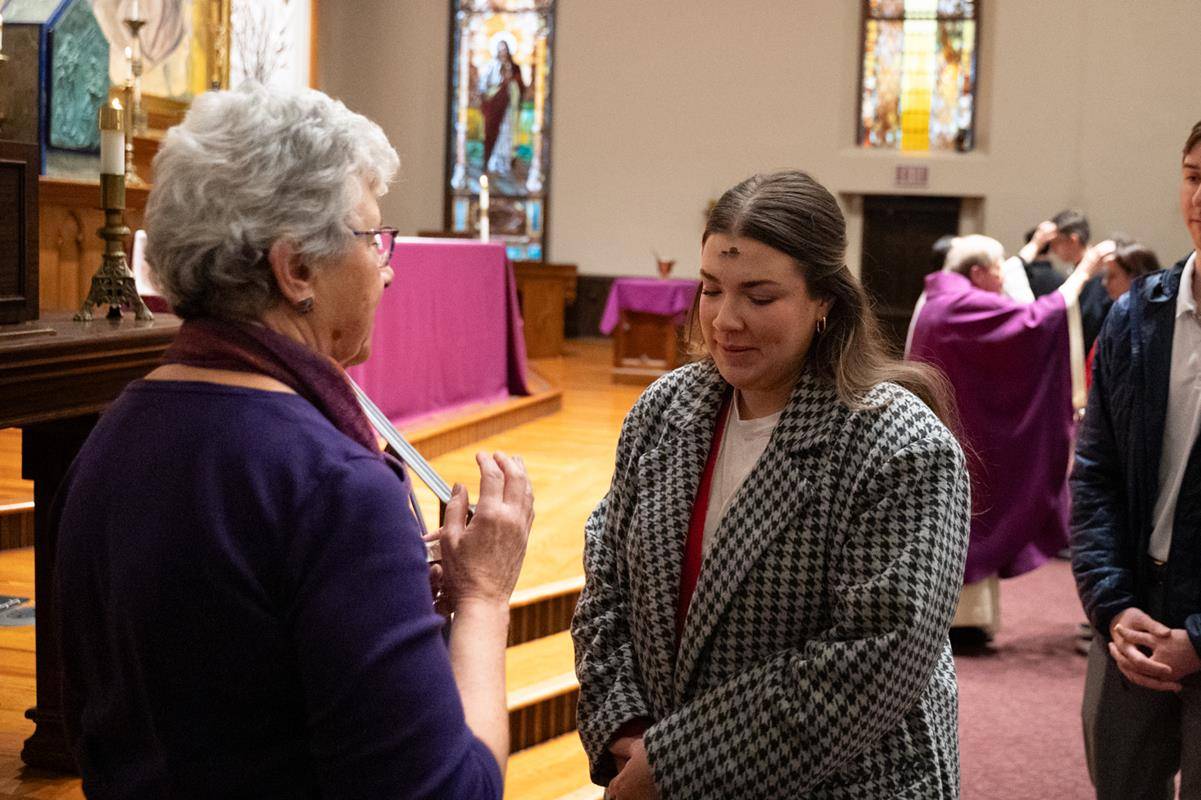 Faithful attend the 7:30 a.m. Ash Wednesday Mass at St. Peter Church in Charlotte. 