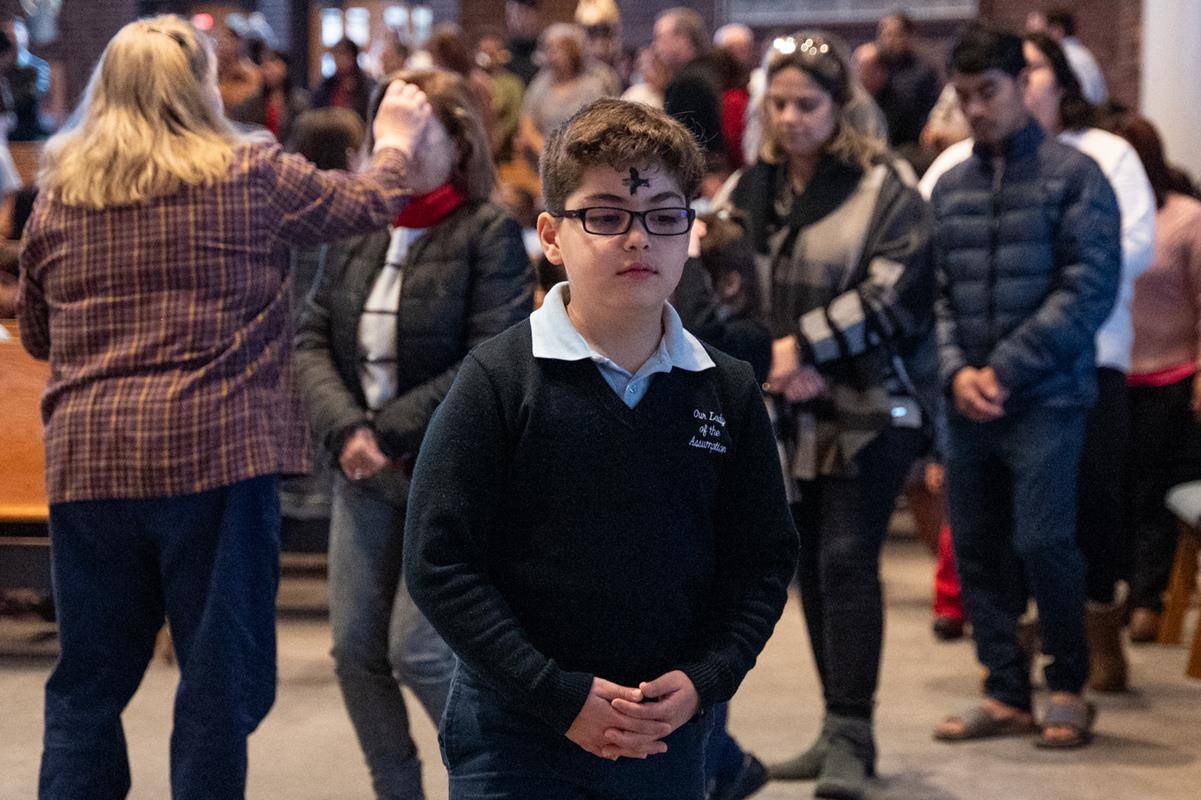 Father Victor Ameh, a priest of the Missionary Society of St. Paul of Nigeria, newly assigned to Our Lady of the Assumption in Charlotte celebrated Ash Wednesday Mass with students from Our Lady of the Assumption School. 