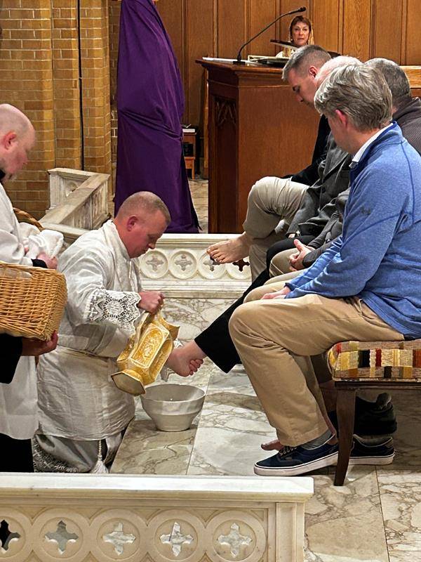 Father Casey Coleman washes the feet of parishioners of Our Lady of Grace Church in Greensboro.