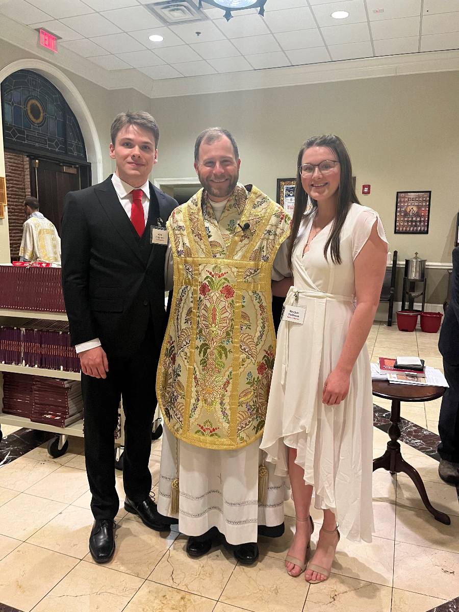 Father John Eckert welcomed siblings Kyle Ferguson and Morgan Hoffman into the faith at the Easter Vigil Mass at Sacred Heart in Salisbury.
