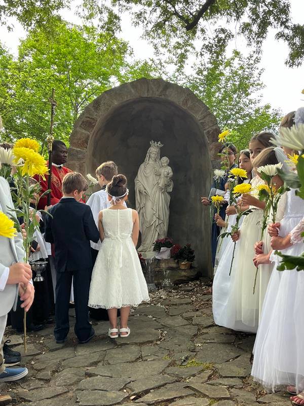 Father Ernest led the students, and the rest of the St. Patrick Catholic School family, in blessing the crown and placing it atop the school's statue of Mary.