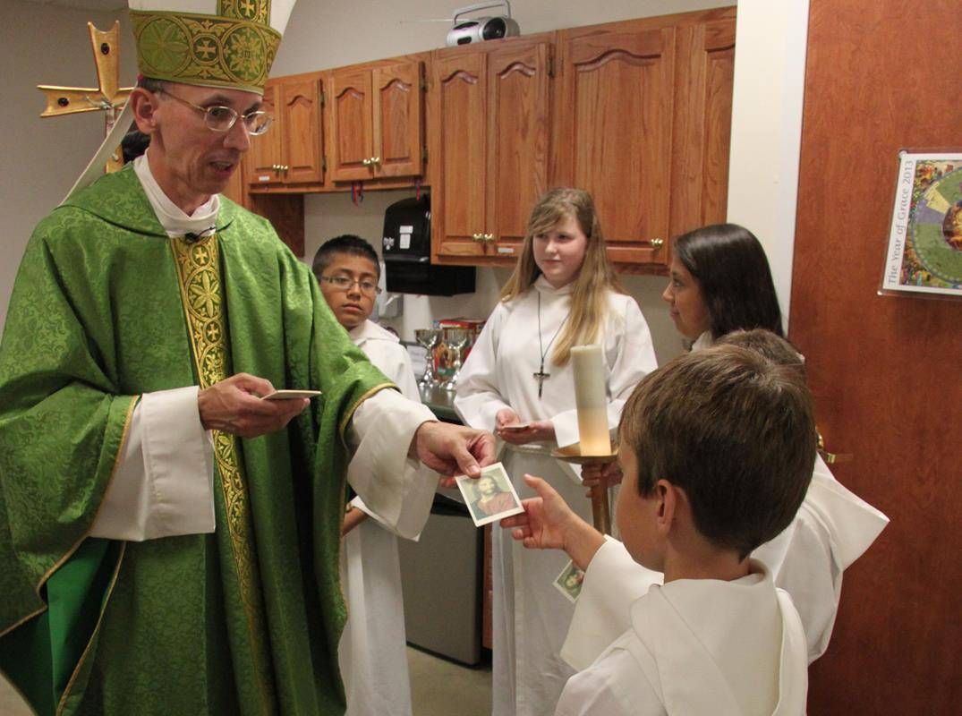 Bishop Jugis shares a prayer card to encourage vocations.