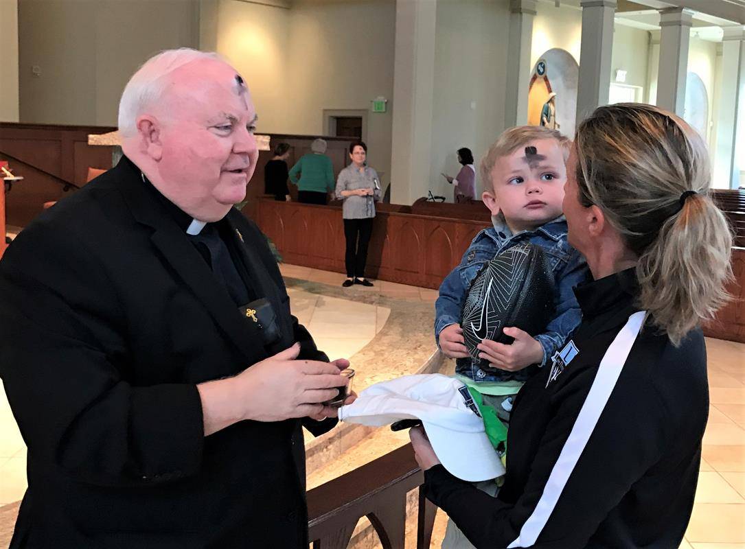 Patrick and Trish Hughes receive ashes at St. Mark Church