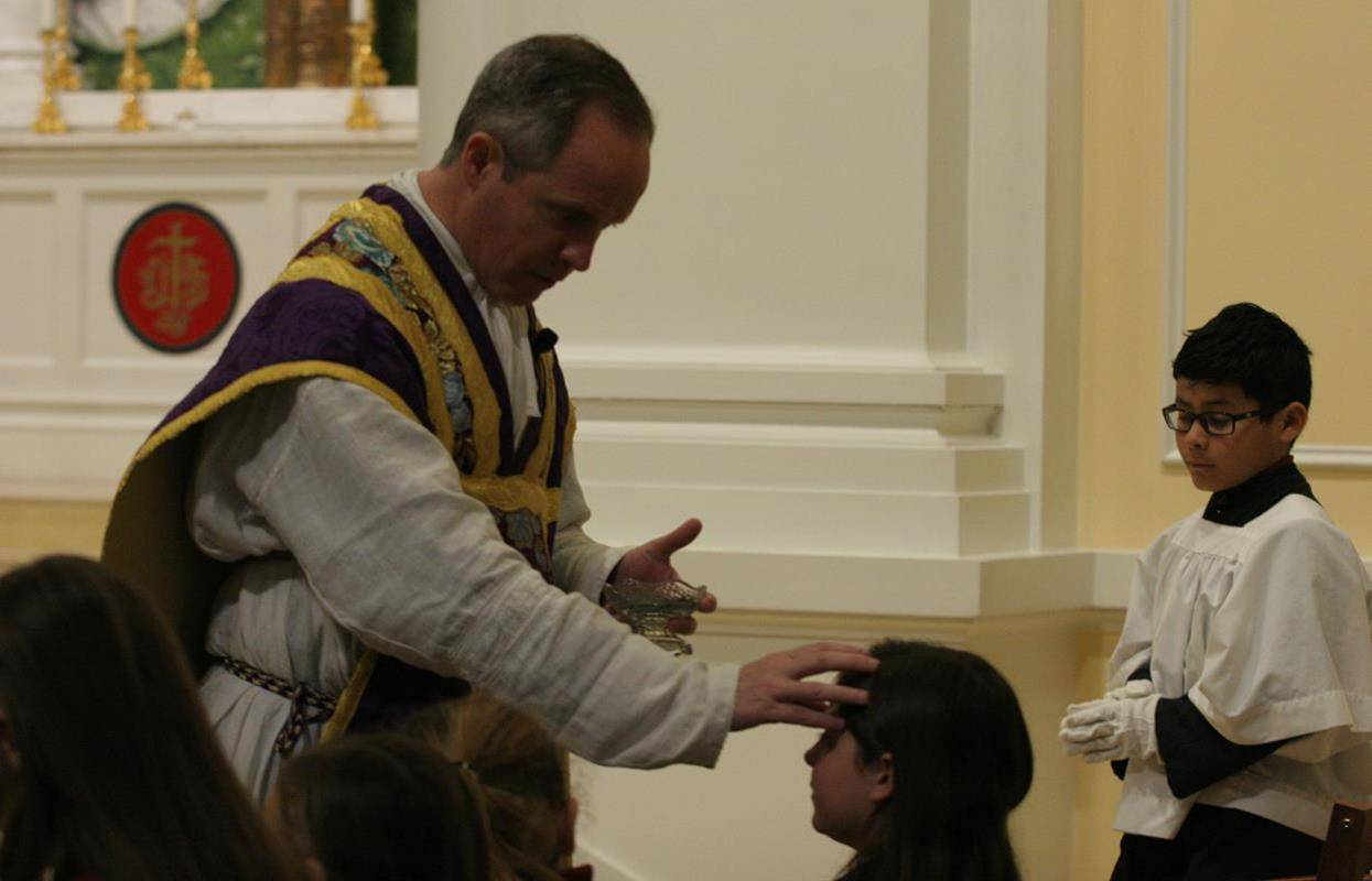 Students at St. Ann School receive ashes. 
