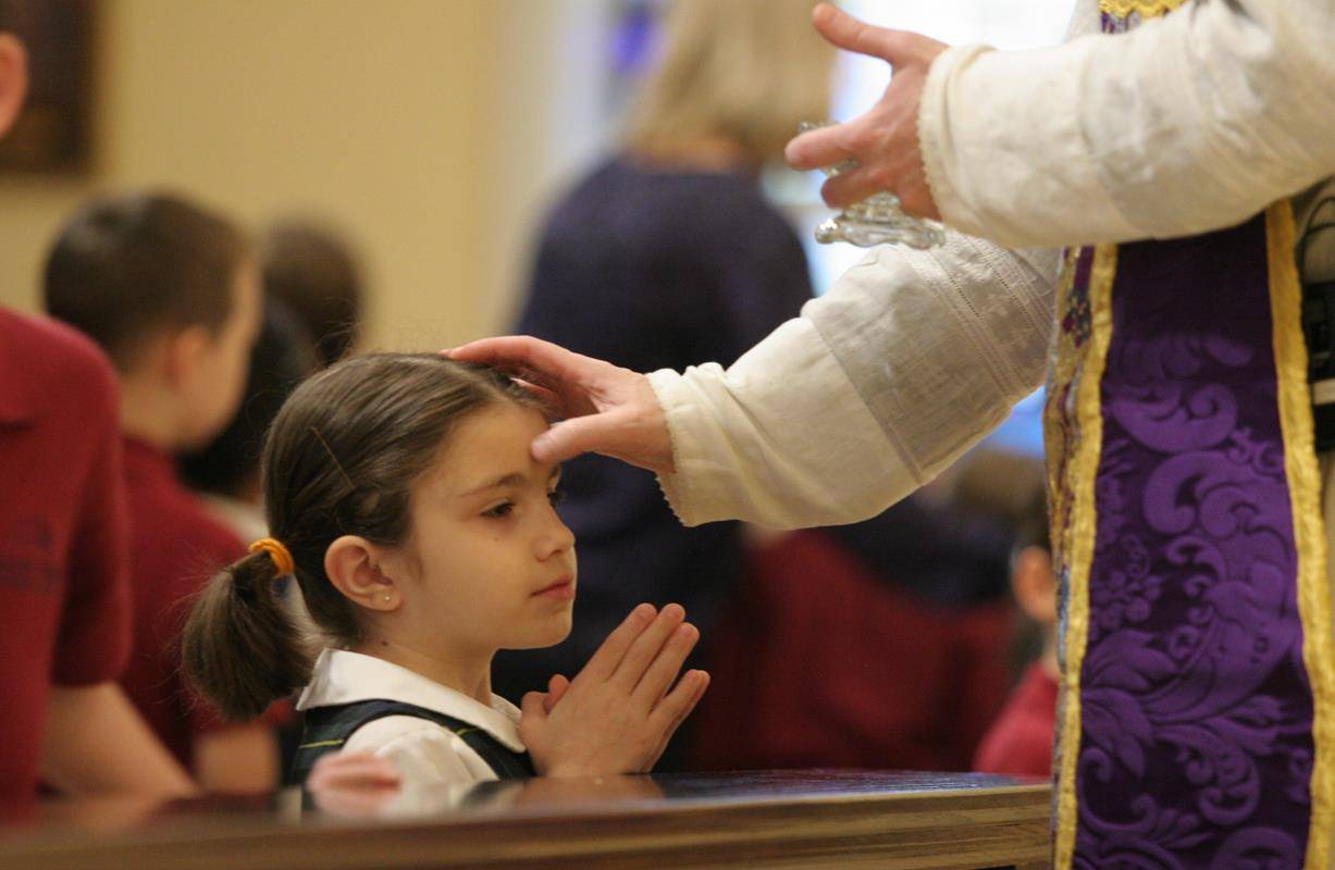 Students at St. Ann School receive ashes. 