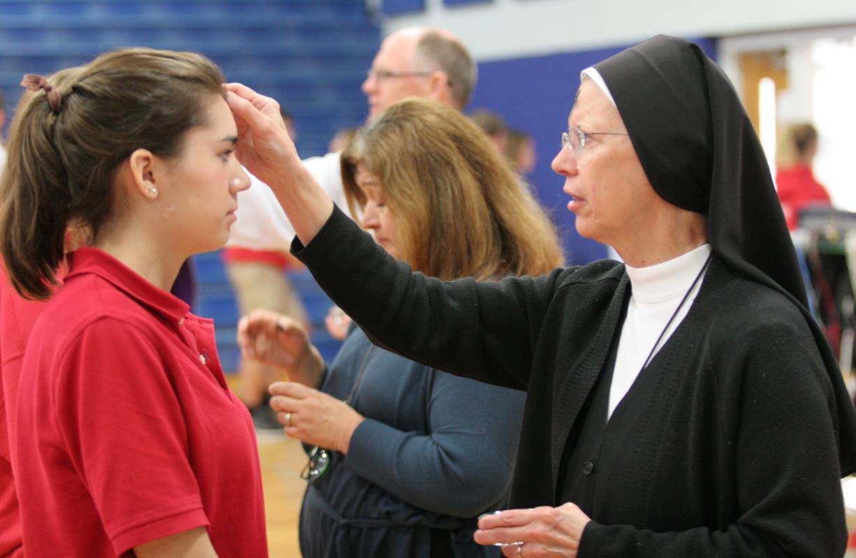 Students at Charlotte Catholic High School during Mass on Ash Wednesday
