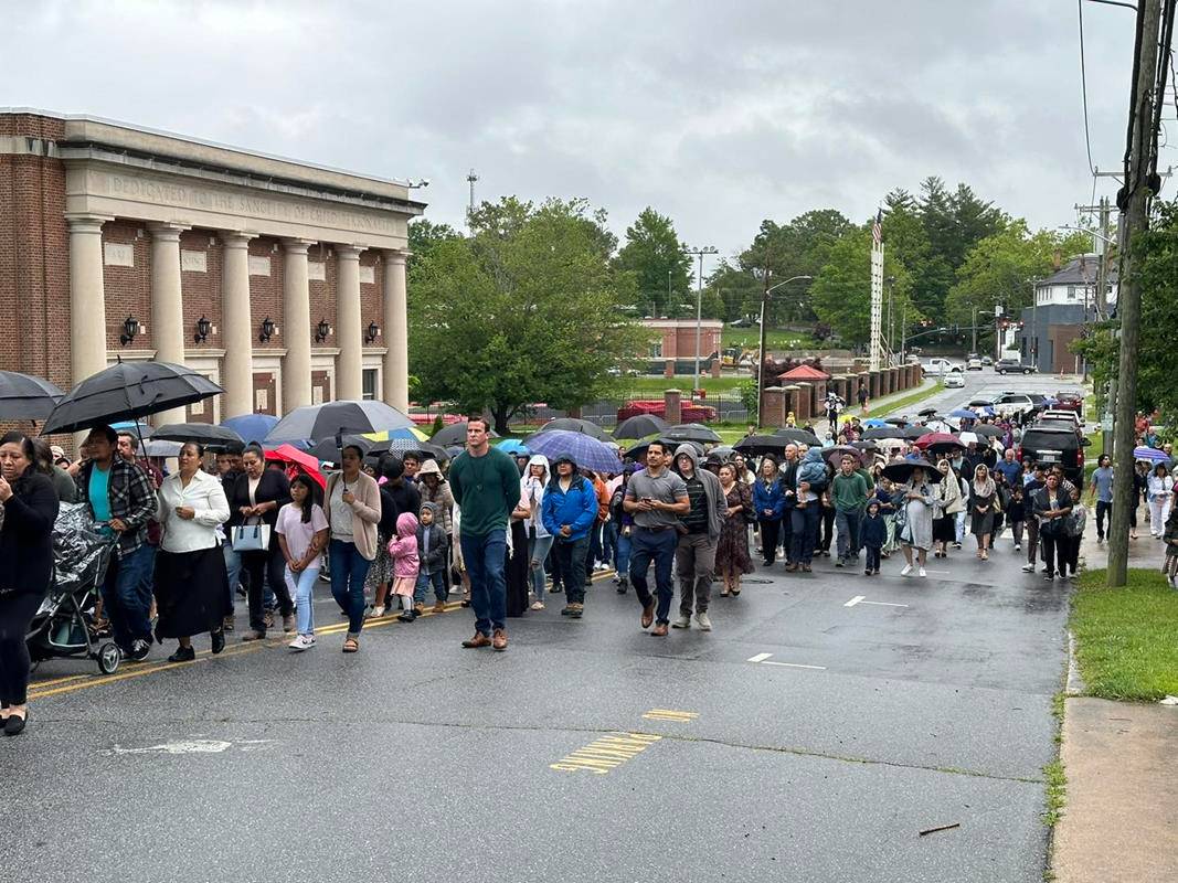 Parishioners followed down Buncombe St. to Bearcat Blvd. to Oakland St. with a stop at the Elizabeth Ann Seton House, home to sisters and the school principal. 