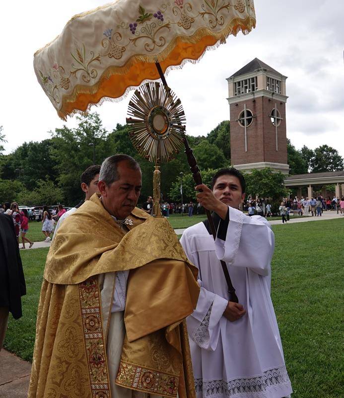 Bishop José Mauricio Vélez García, Auxiliary Bishop of Medellín, Colombia, celebrates Mass and leads a Eucharistic Procession around St. Mark Church in Huntersville.