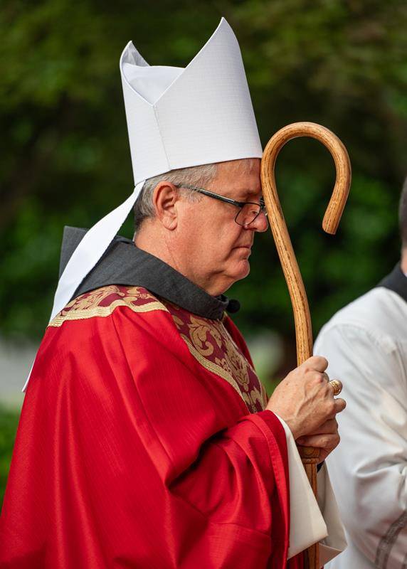 Bishop Martin took a quiet moment to pray before entering the church.