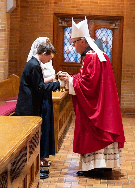Newly confirmed Nathanael Foppe and Evelyn Braden presented the gifts to Bishop Martin.