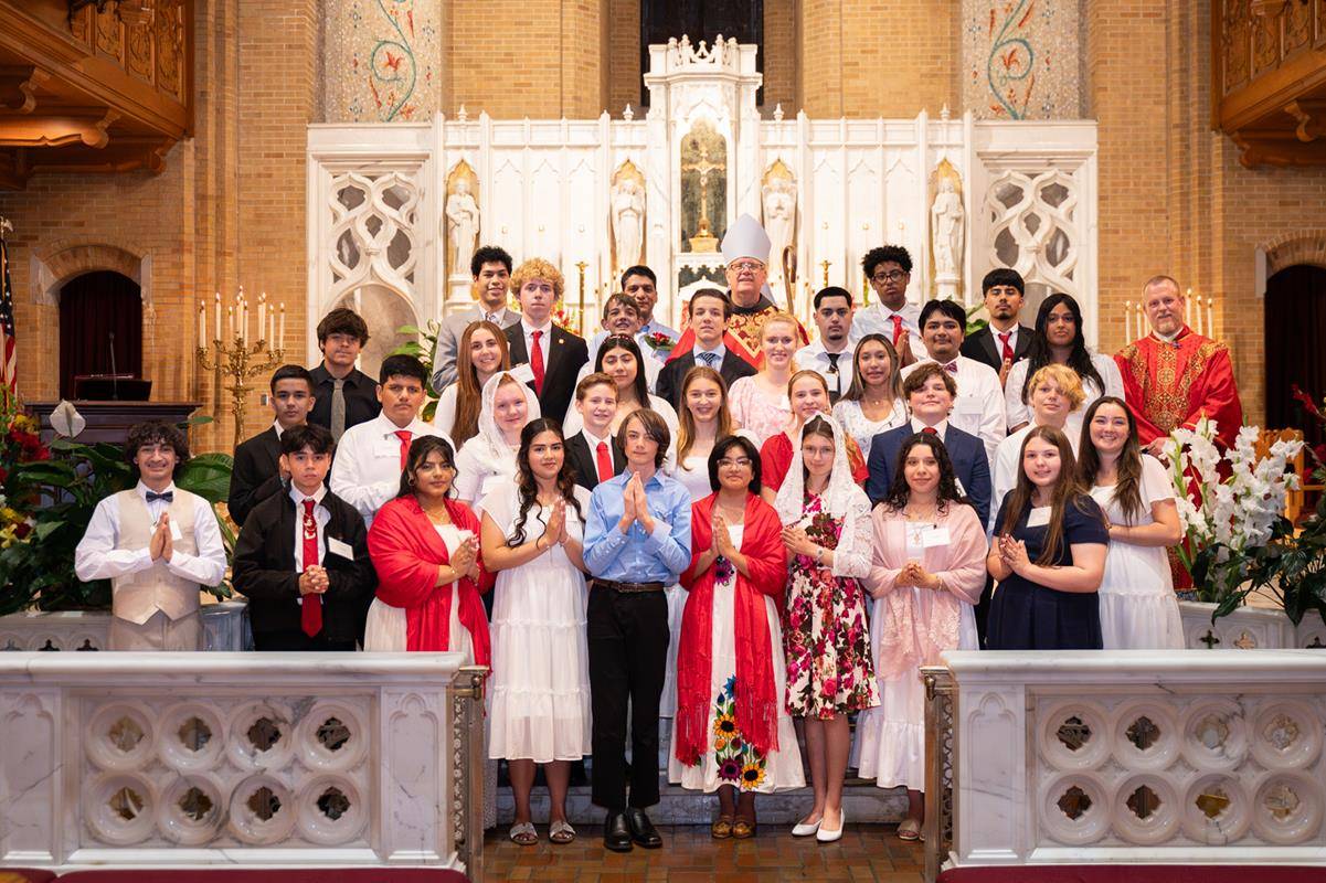 The newly confirmed young people posed for a group photo with Bishop Martin and Father Casey Coleman, pastor.