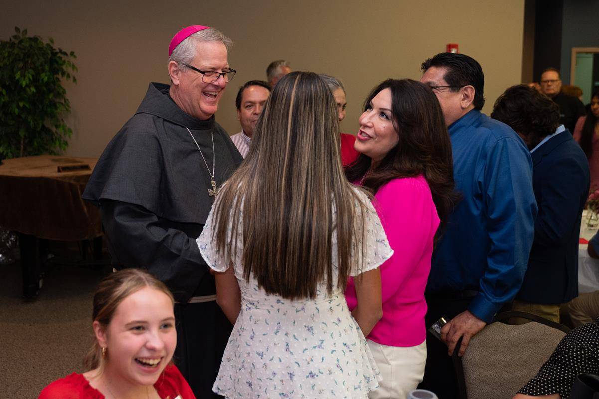 Bishop Martin mingled with families in a reception following Mass.