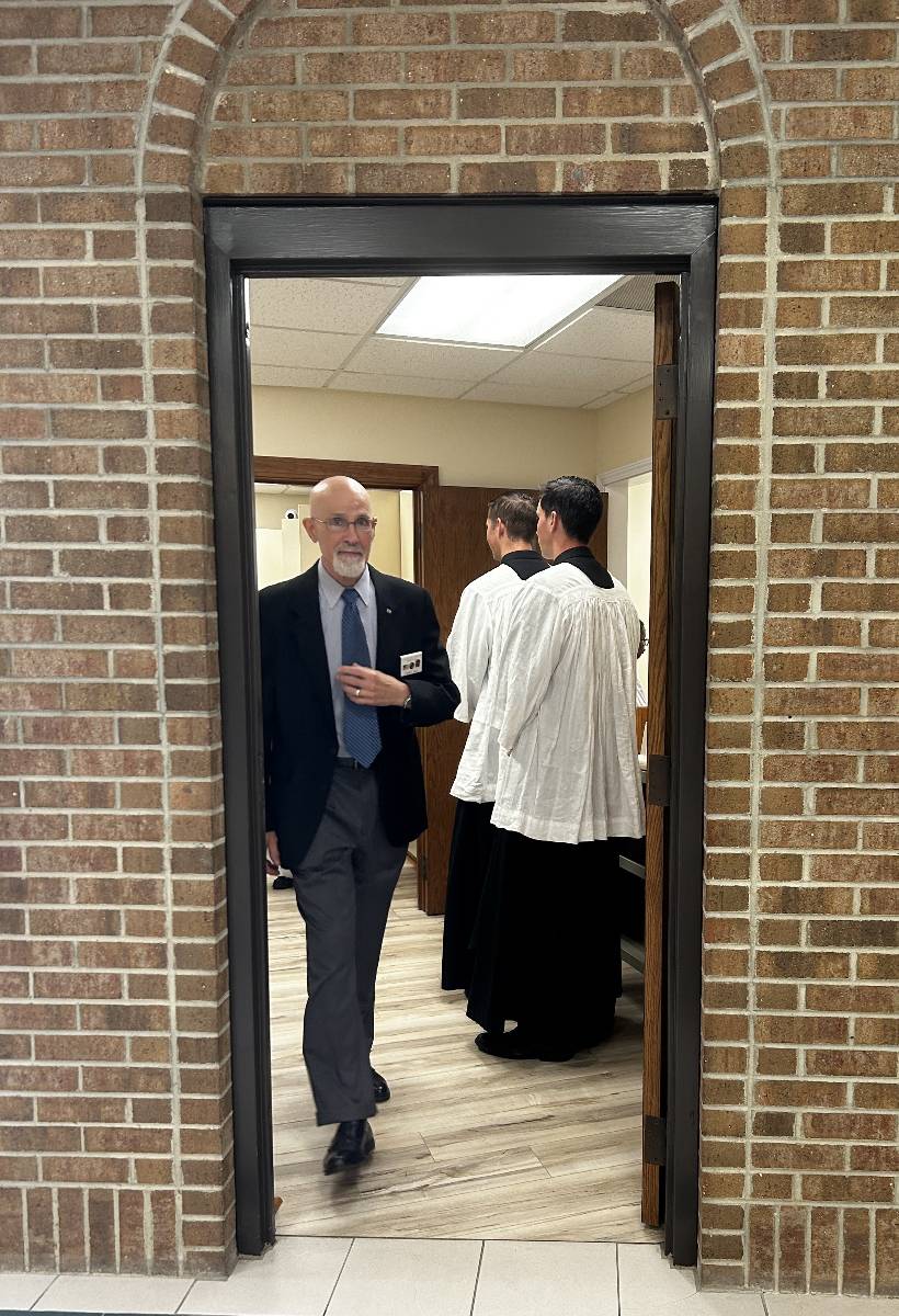 Seminarians and Knight of Columbus Larry Hill prepare for Mass.
