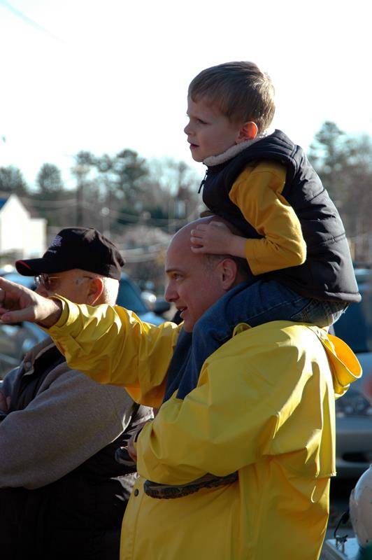 Monsignor Marcaccio and a young parishioner watch the demolition of the old St. Pius X Church in 2008. Inspired by his vision, parishioners donated $6.6 million toward a new church, which opened in 2010.