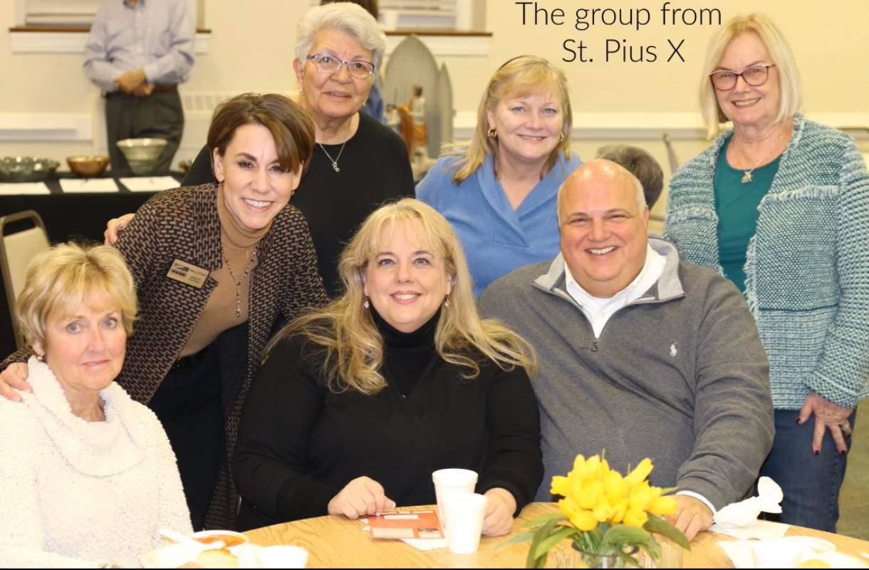 Monsignor Marcaccio with St. Pius X staff at a fundraiser for Greensboro Urban Ministry, which was a primary beneficiary of the parish’s support.