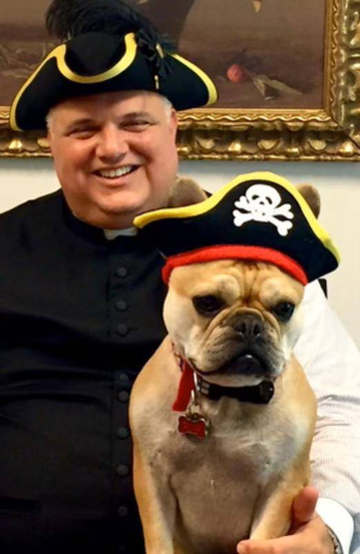A priest and his pup celebrate “Talk Like a Pirate Day.” As a child, Monsignor Marcaccio dreamed of becoming a pirate and never lost his sense of adventure, parishioners said.