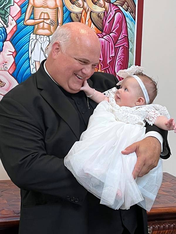 Monsignor Marcaccio loved children and baptisms – and revels here with both.