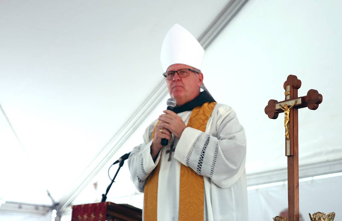 Bishop Martin urged parishioners to unite as living stones to provide a firm foundation for their faith community, as firm as the church building they are starting to build.
