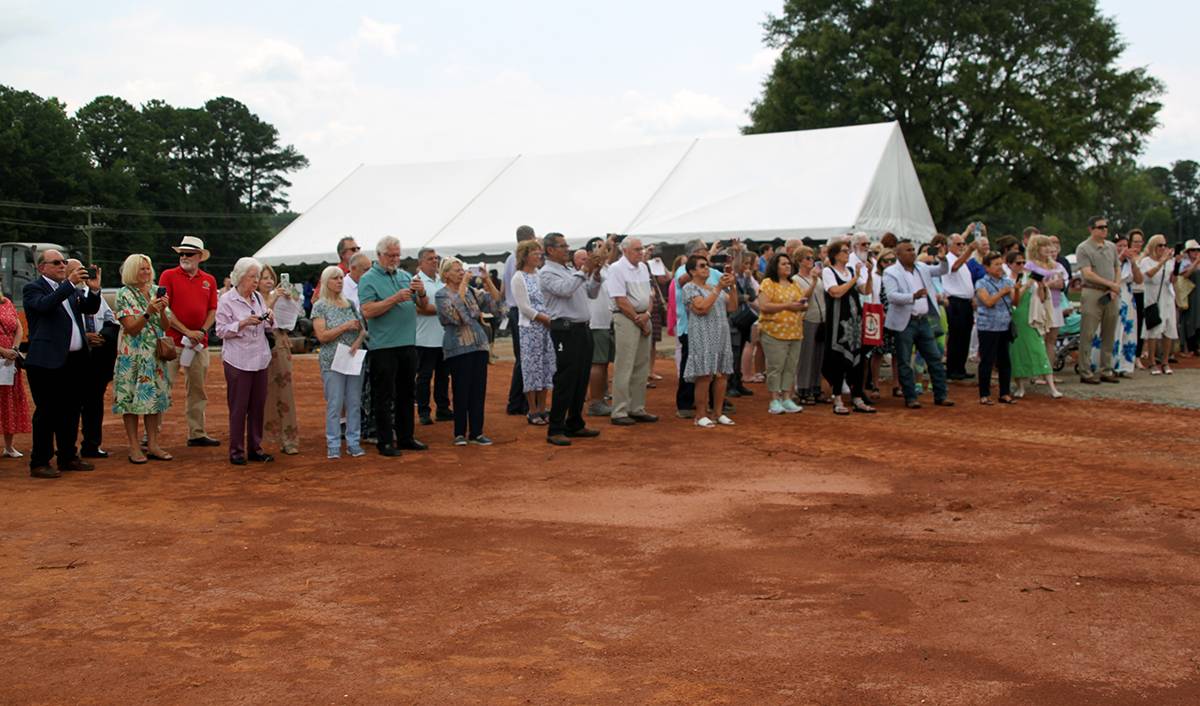 Parishioners braved a muddy construction site to take part in the groundbreaking and blessing.