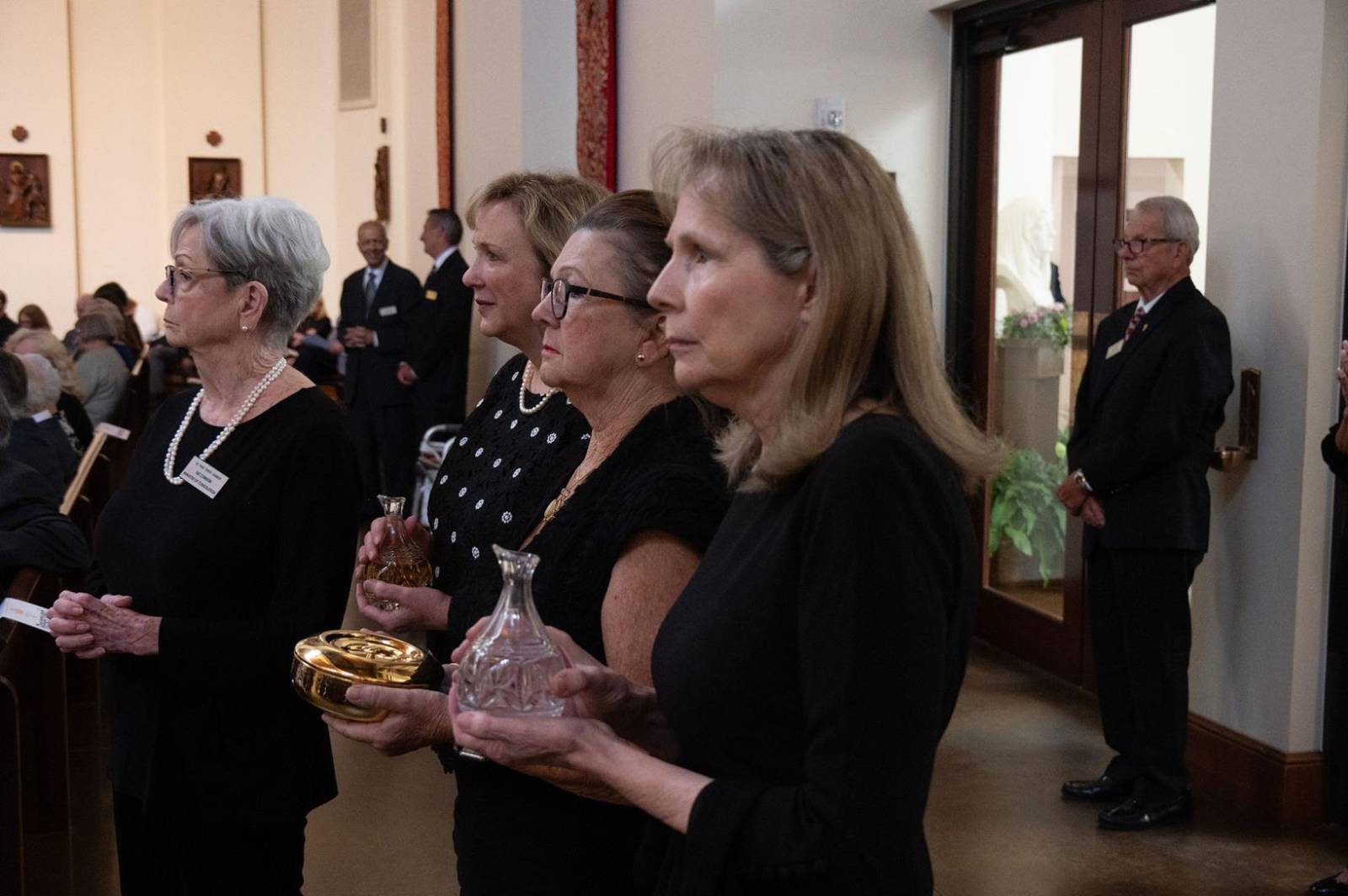 Some of Msgr. Marcaccio’s family and friends bring up the offertory gifts.