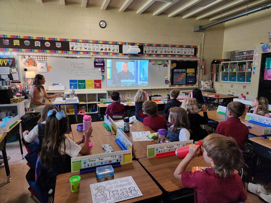Students at St. Ann School watch a video message from Bishop Martin on the first day of school.