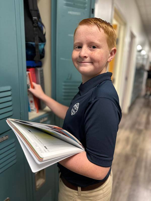 Students smile as they arrive at St. Pius X School in Greensboro for the first day of school.