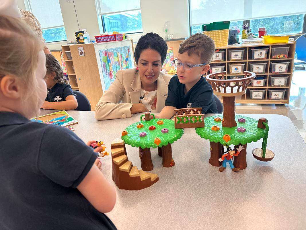 Students smile as they arrive at St. Pius X School in Greensboro for the first day of school.