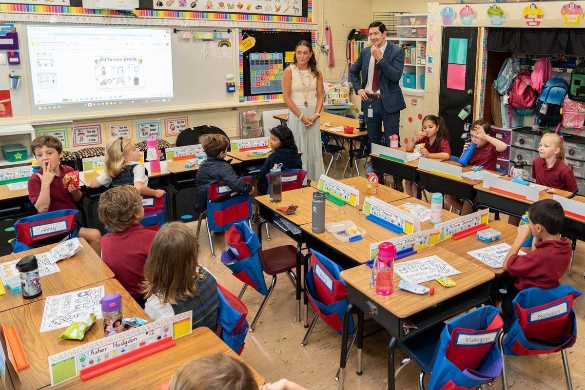 Dr. Greg Monroe, Superintendent of schools, visits with students at St. Ann School in Charlotte on the first day of school.
