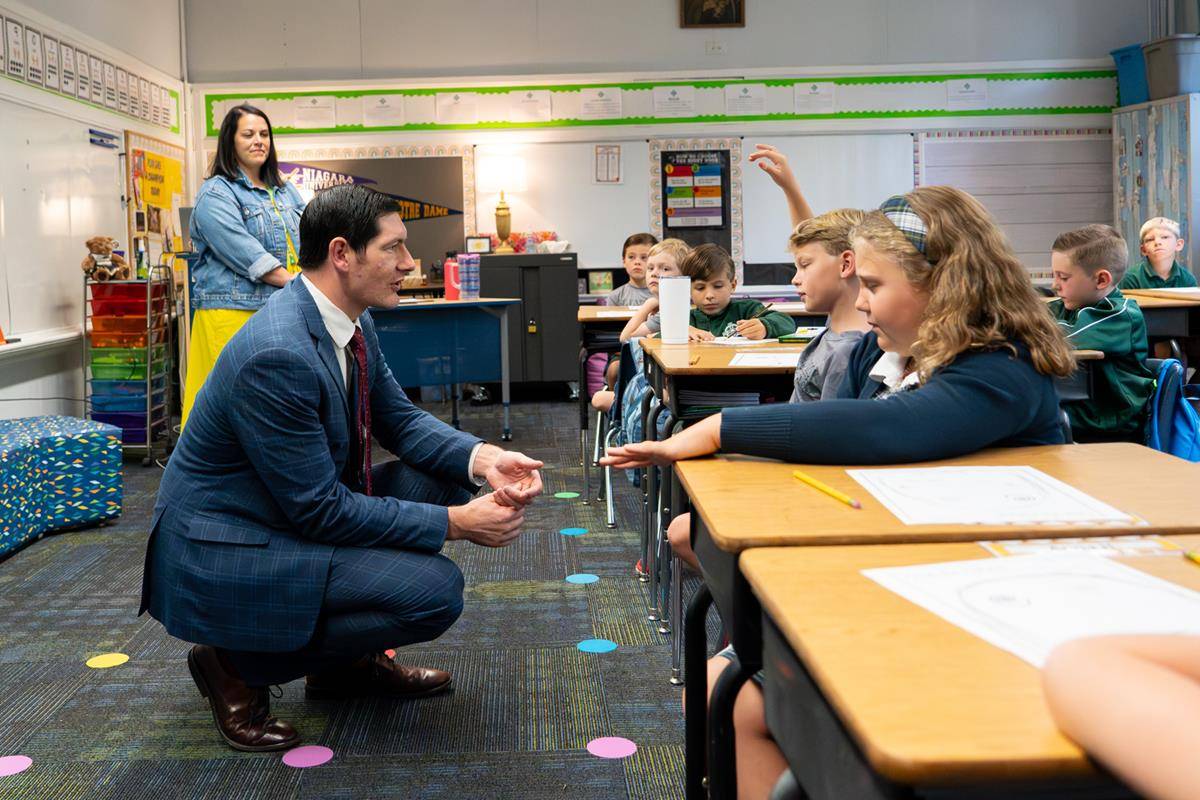 Dr. Greg Monroe, Superintendent of schools, visits with students at St. Patrick School in Charlotte on the first day of school. 