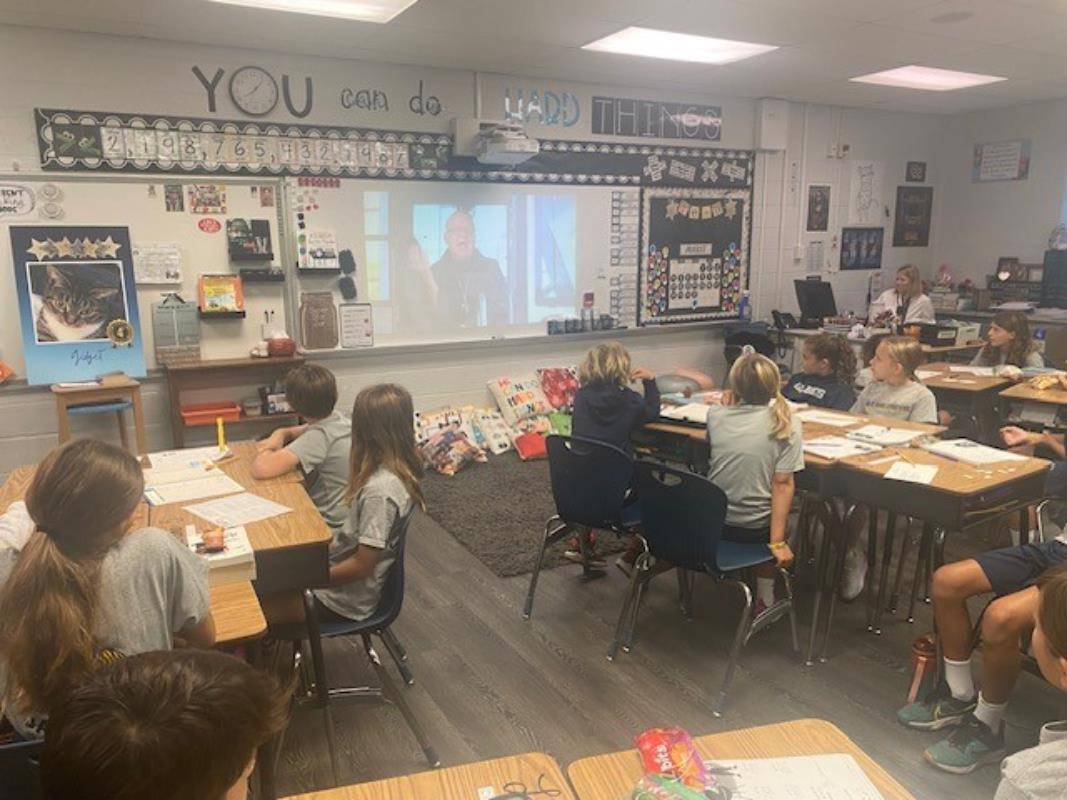 Students at St. Gabriel School in Charlotte watch a message from Bishop Martin on the first day of school. 